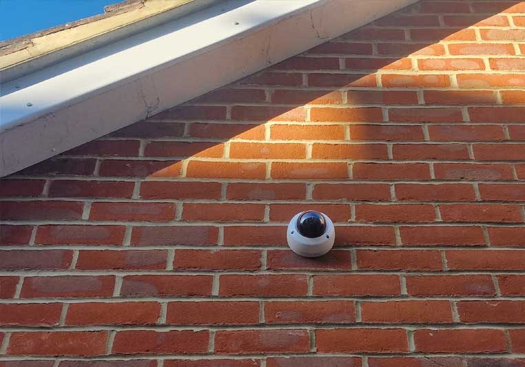 dome-camera-with-red-brick-background